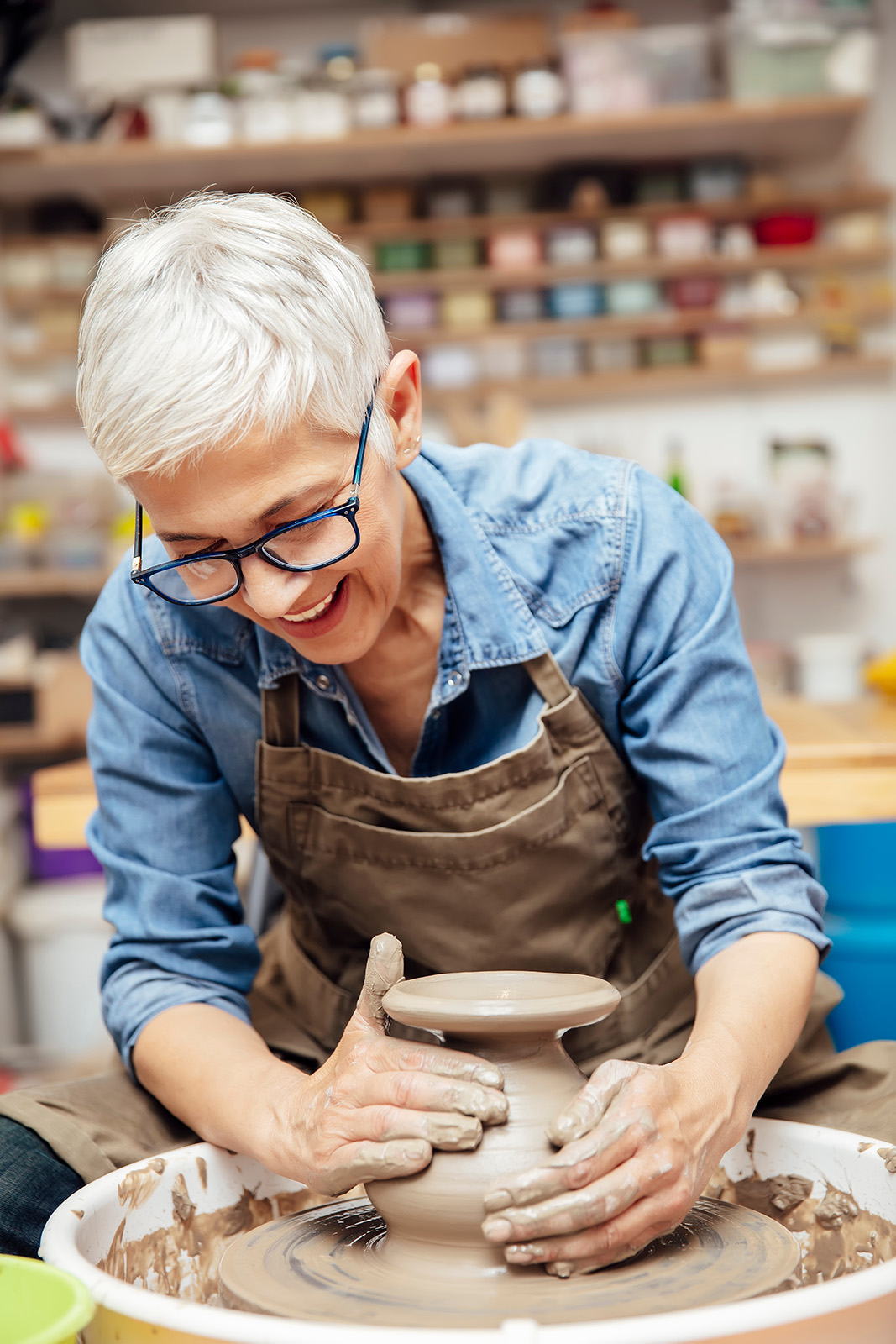 AdobeStock_286532253_Preview senior woman doing pottery