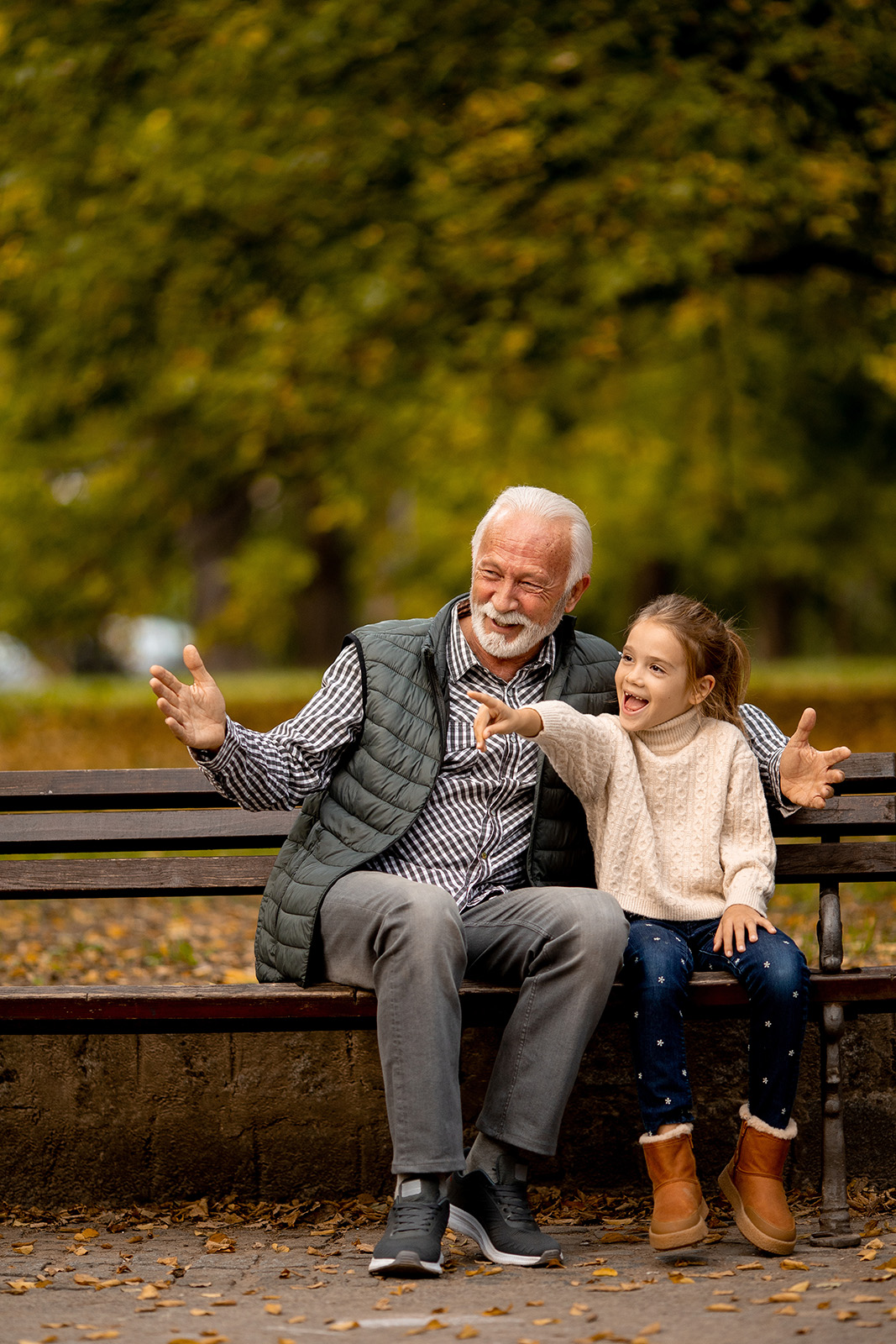 AdobeStock_539229003_Preview grandfather and granddaughter on bench